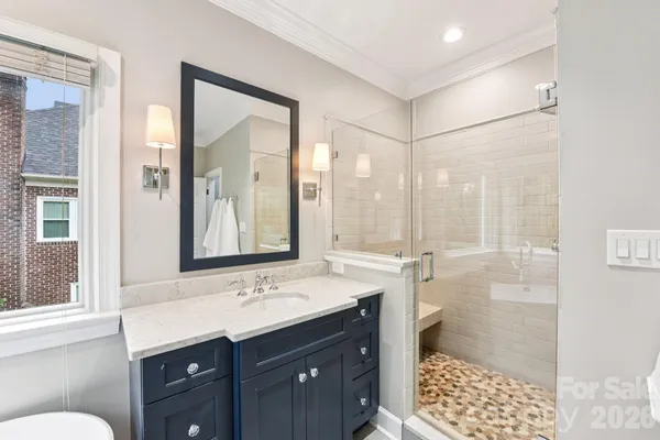 a bathroom with a shower sink and mirror