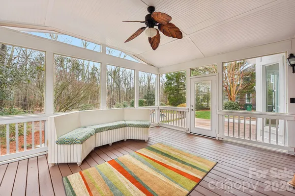 a living room with wooden floor furniture and a large window
