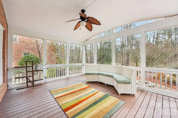 a living room with wooden floor furniture and a large window