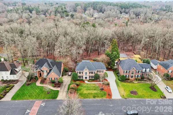 an aerial view of a house with garden space and street view