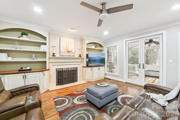 a living room with furniture fireplace and flat screen tv