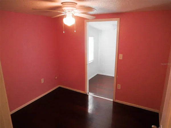 an empty room with wooden floor