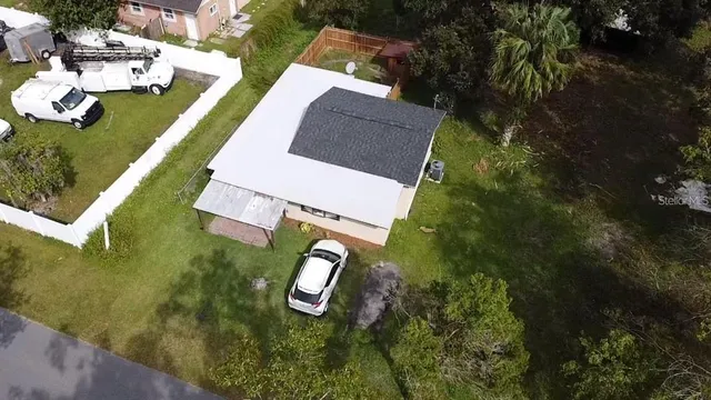 an aerial view of house with yard