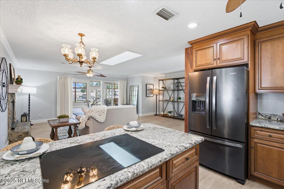 4447 Cedar Road Orange Park, FL 32065 - Photo 15 of 100 a living room with stainless steel appliances furniture a chandelier and kitchen view