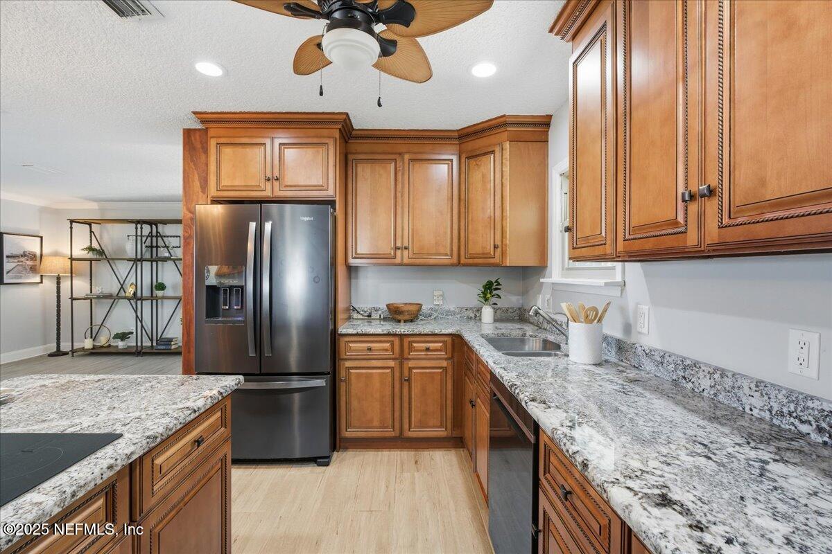 4447 Cedar Road Orange Park, FL 32065 - Photo 16 of 100 a kitchen with stainless steel appliances granite countertop a sink a stove and a refrigerator