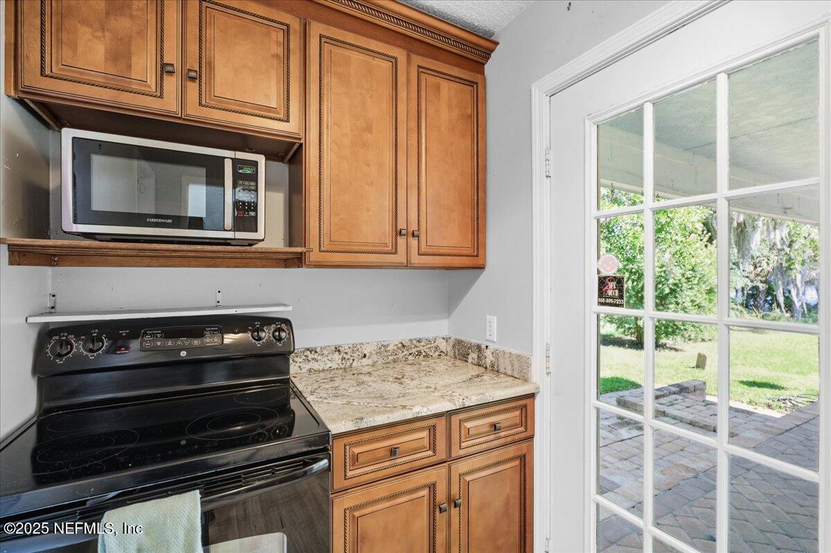 4447 Cedar Road Orange Park, FL 32065 - Photo 18 of 100 a kitchen with wooden cabinets and a stove top oven