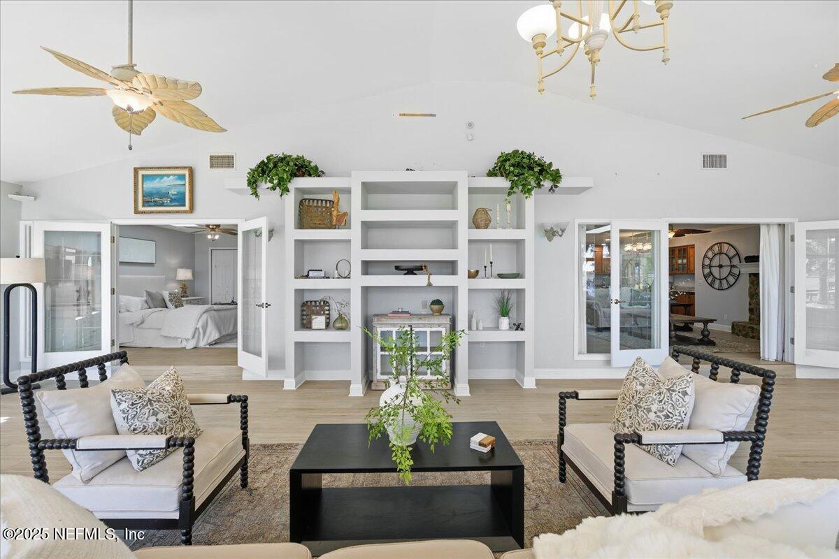 4447 Cedar Road Orange Park, FL 32065 - Photo 31 of 100 a living room with furniture a chandelier and a flat screen tv