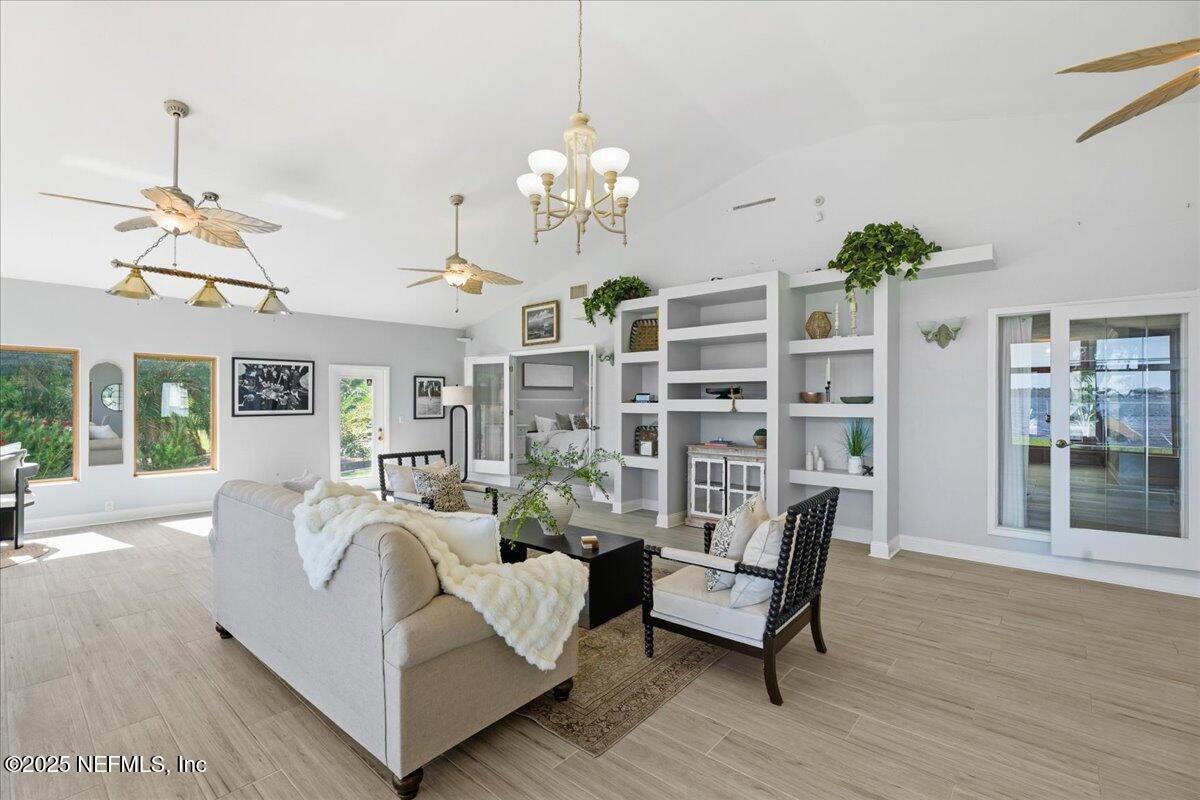 4447 Cedar Road Orange Park, FL 32065 - Photo 32 of 100 a living room with furniture chandelier and wooden floor