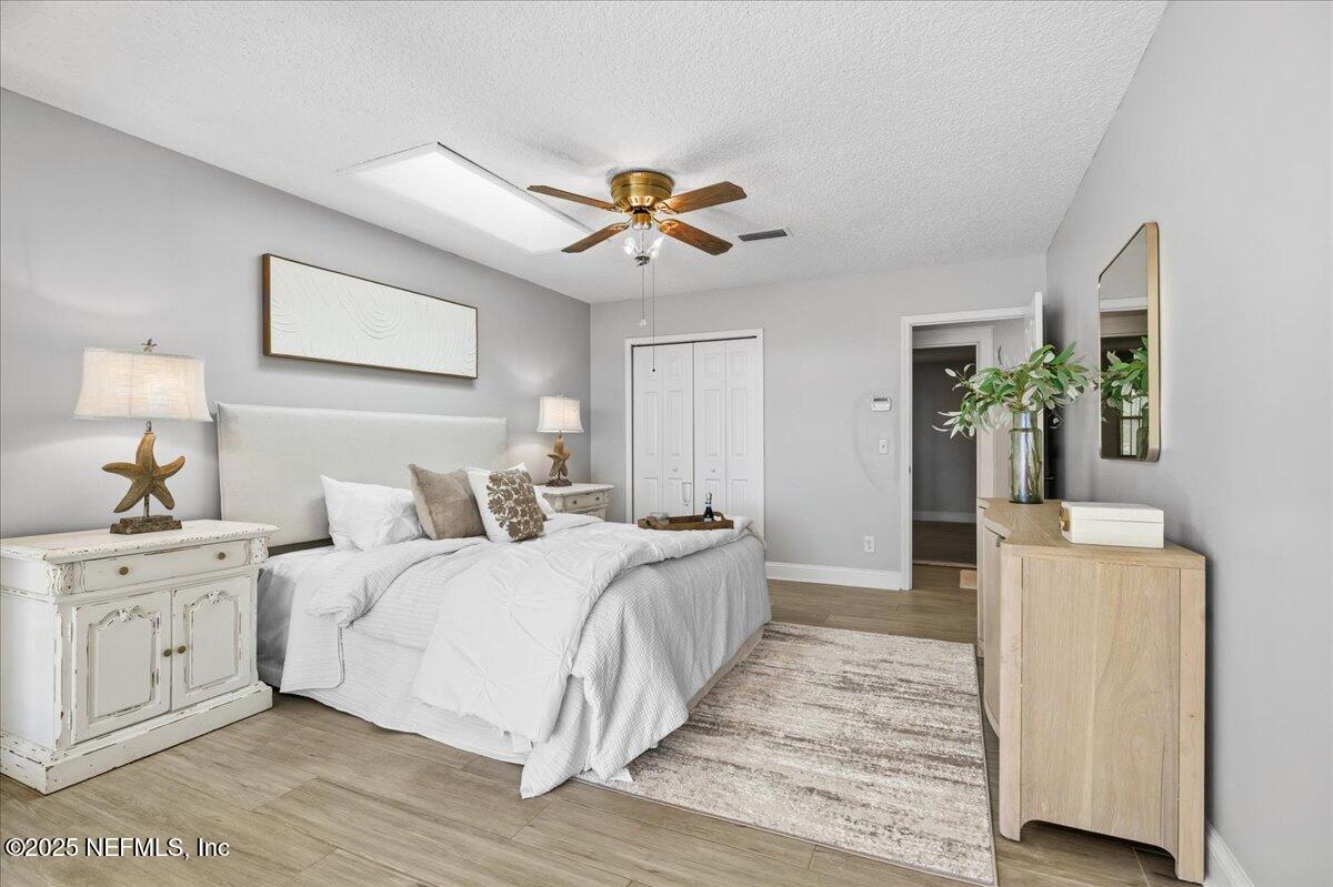 4447 Cedar Road Orange Park, FL 32065 - Photo 47 of 100 a bedroom with a bed and a chandelier