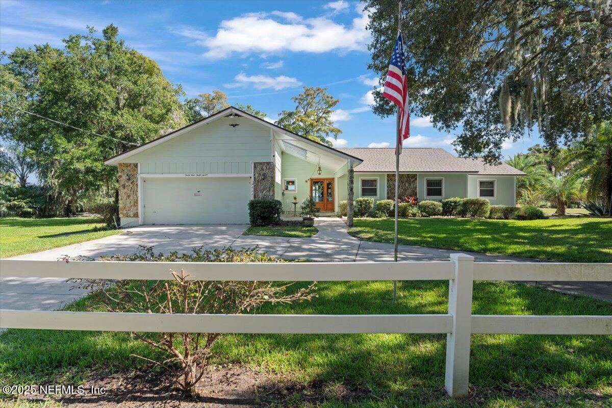 4447 Cedar Road Orange Park, FL 32065 - Photo 5 of 100 a front view of a house with a yard and potted plants