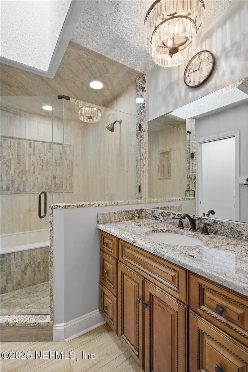 4447 Cedar Road Orange Park, FL 32065 - Photo 53 of 100 a bathroom with a sink a large mirror and a shower