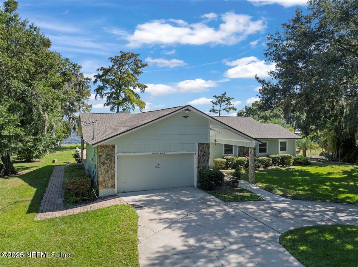 4447 Cedar Road Orange Park, FL 32065 - Photo 61 of 100 a view of a yard in front of a house with plants and large tree