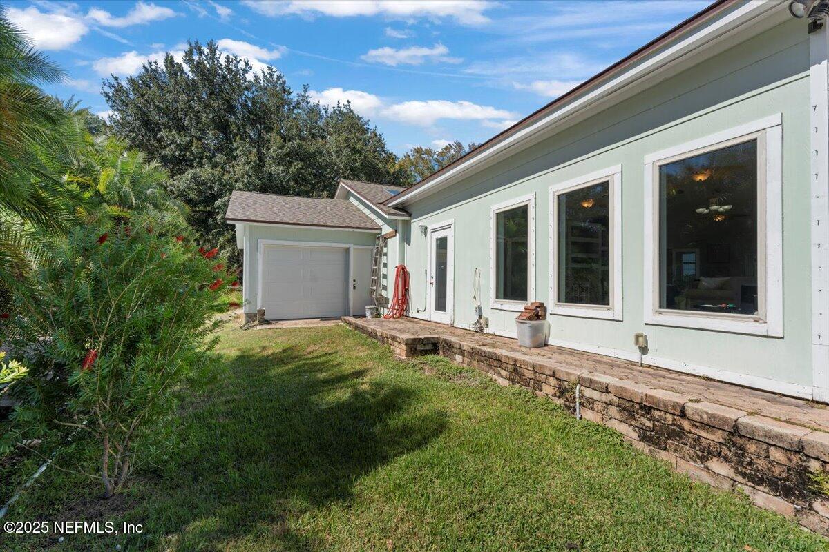 4447 Cedar Road Orange Park, FL 32065 - Photo 71 of 100 a backyard of a house with table and chairs