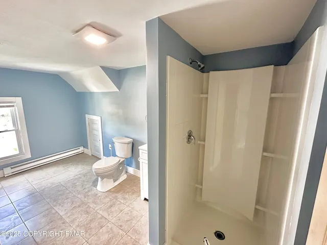 a bathroom with a shower and a toilet