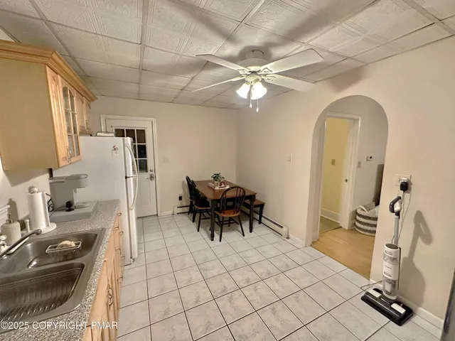 a dining room with furniture and a chandelier