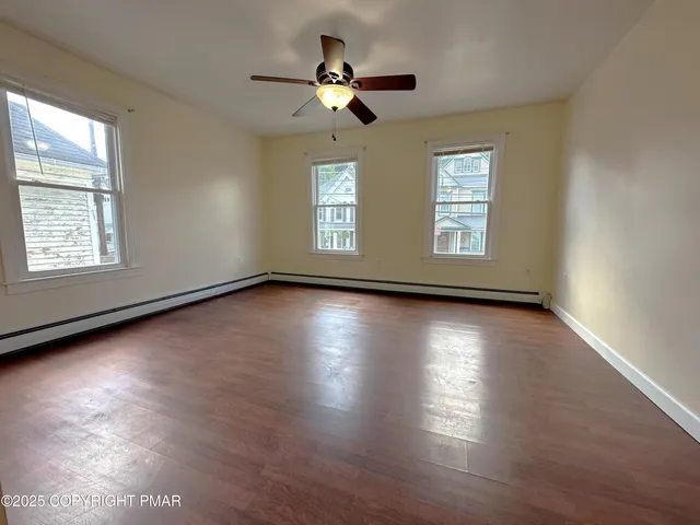 a view of room window and wooden floor