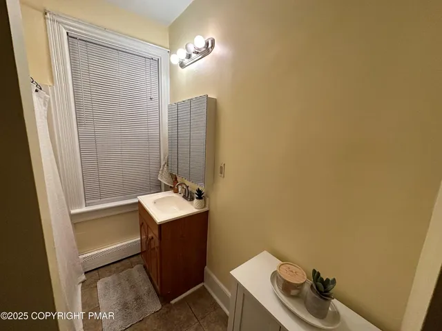 a bathroom with a sink a toilet and tub