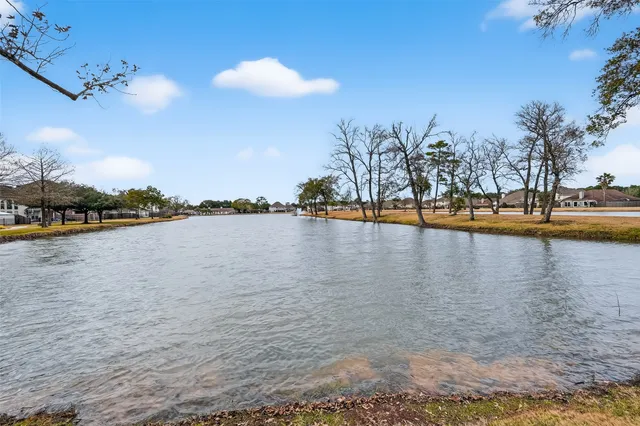a view of a lake with houses in the background