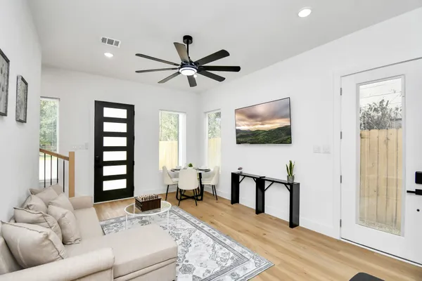 a living room with furniture and wooden floor