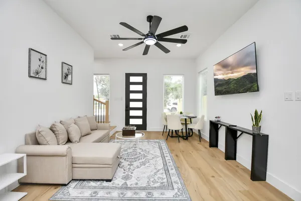 a living room with furniture and a flat screen tv