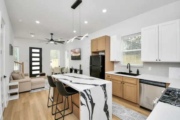 a kitchen with stainless steel appliances kitchen island granite countertop a sink and cabinets