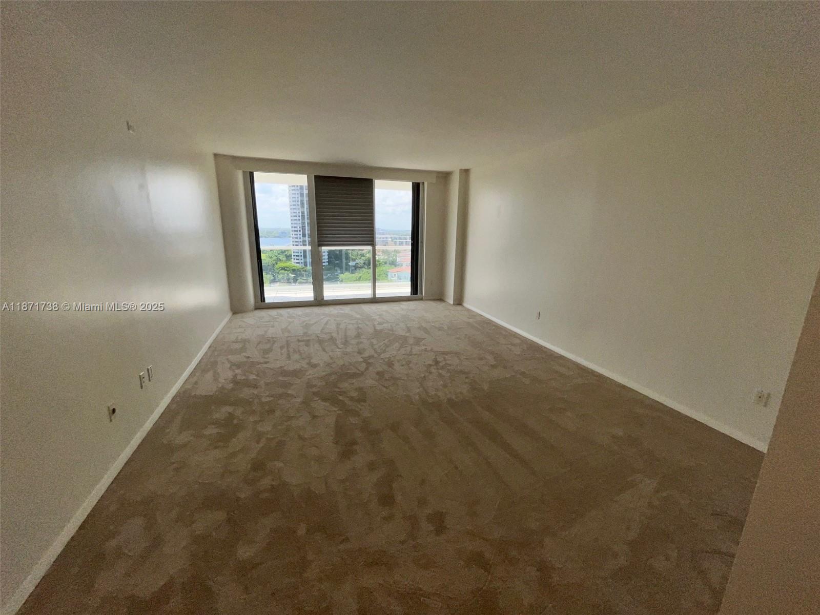 2600 East Island Boulevard, Unit 1503 Aventura, FL 33160 - Photo 11 of 36 an empty room with windows