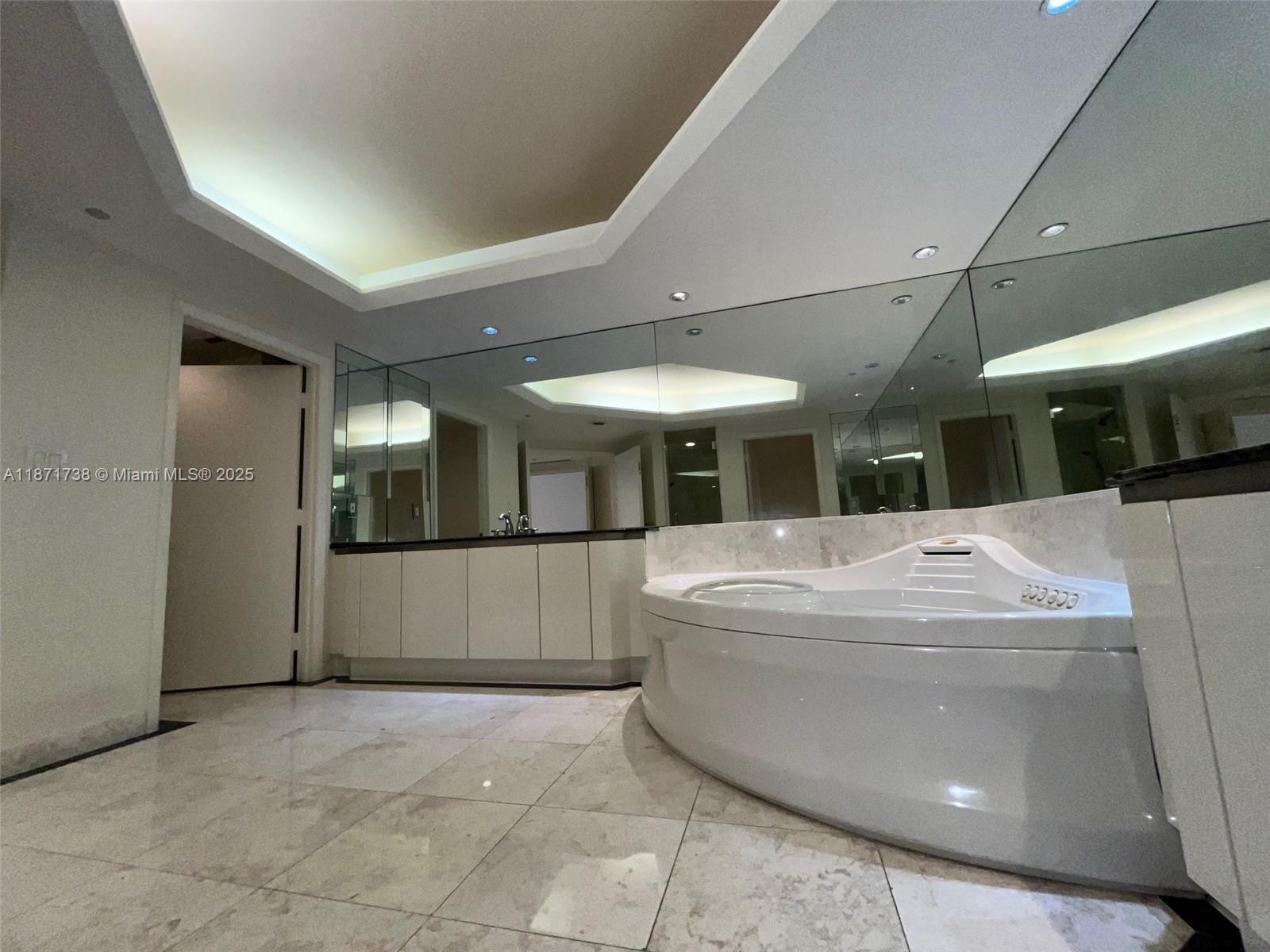 2600 East Island Boulevard, Unit 1503 Aventura, FL 33160 - Photo 14 of 36 a large white tub sitting in a room