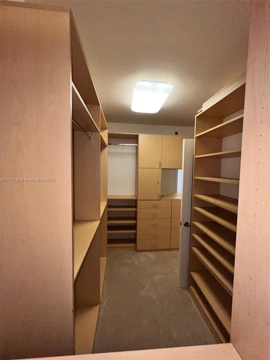 2600 East Island Boulevard, Unit 1503 Aventura, FL 33160 - Photo 16 of 36 a view of walk in closet with empty racks
