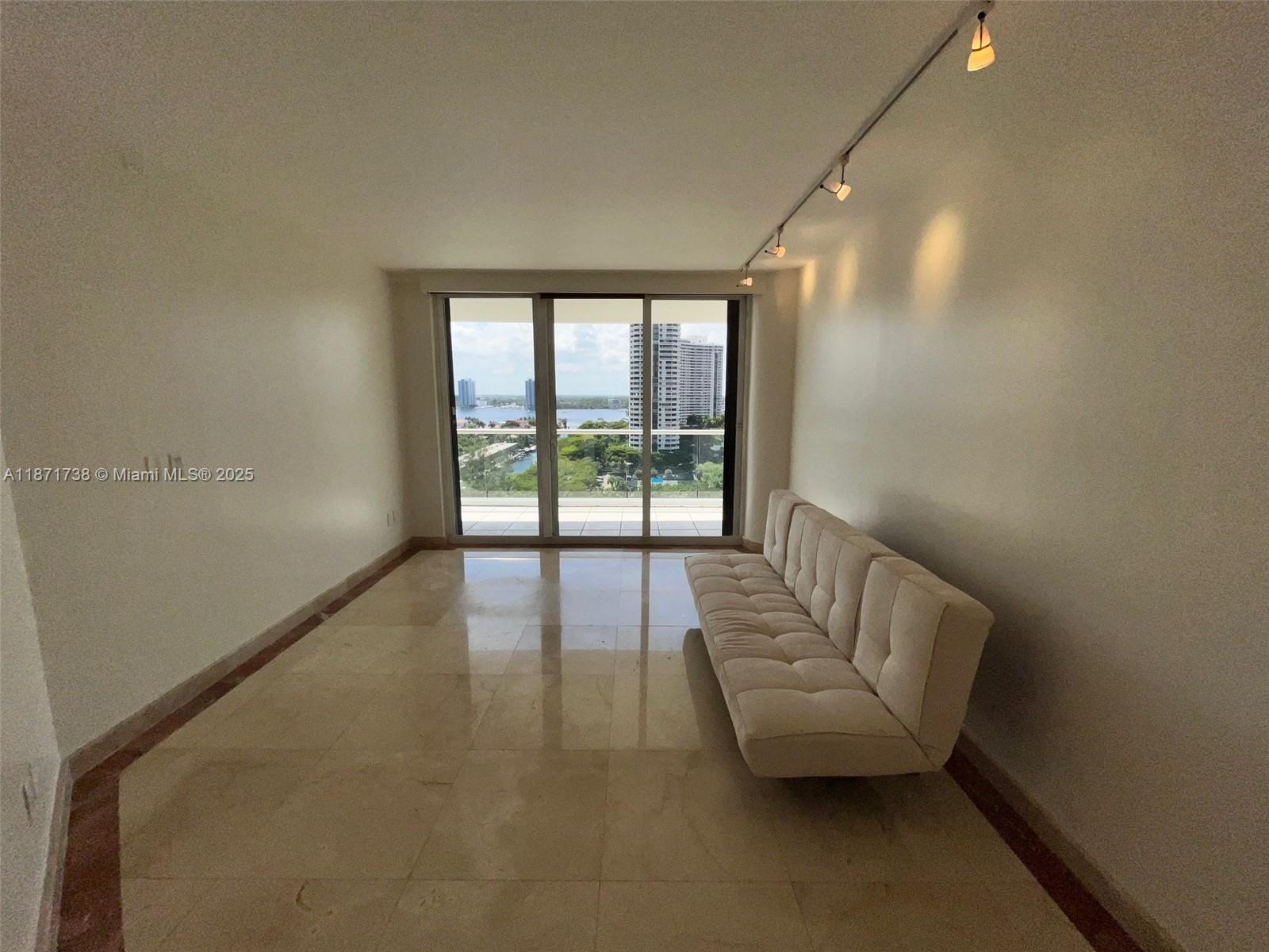 2600 East Island Boulevard, Unit 1503 Aventura, FL 33160 - Photo 22 of 36 a living room with furniture and a large window