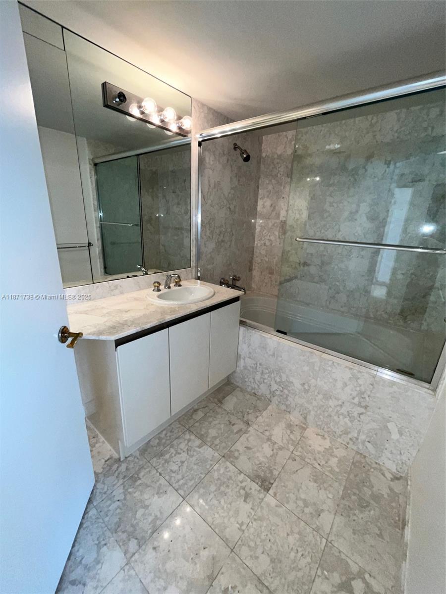 2600 East Island Boulevard, Unit 1503 Aventura, FL 33160 - Photo 25 of 36 a bathroom with a sink mirror and shower