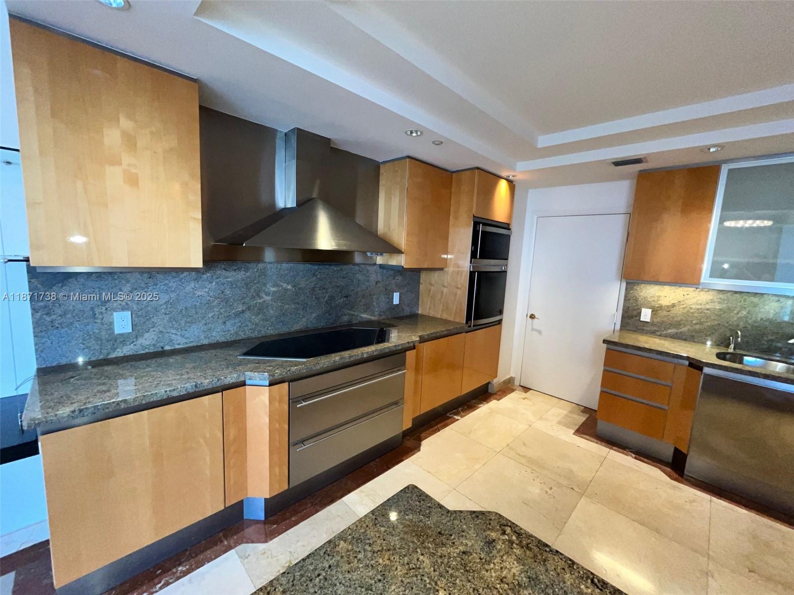 2600 East Island Boulevard, Unit 1503 Aventura, FL 33160 - Photo 8 of 36 a kitchen with stainless steel appliances granite countertop a sink stove and refrigerator