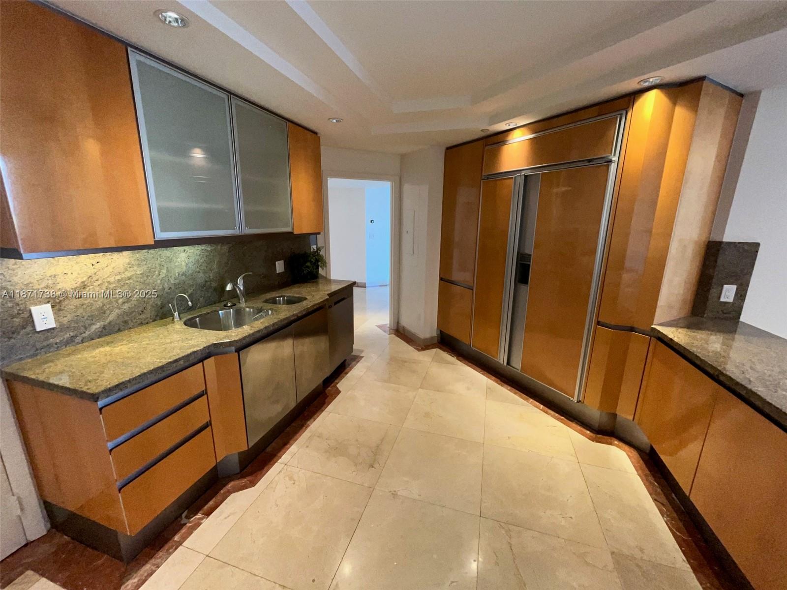 2600 East Island Boulevard, Unit 1503 Aventura, FL 33160 - Photo 9 of 36 a kitchen with stainless steel appliances granite countertop a stove a sink and a refrigerator
