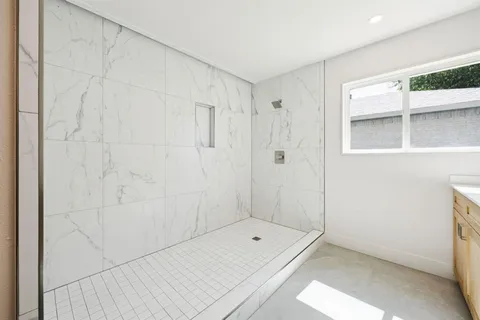 a bathroom with a shower and a window