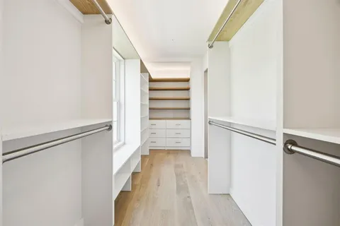 a view of walk in closet with empty racks