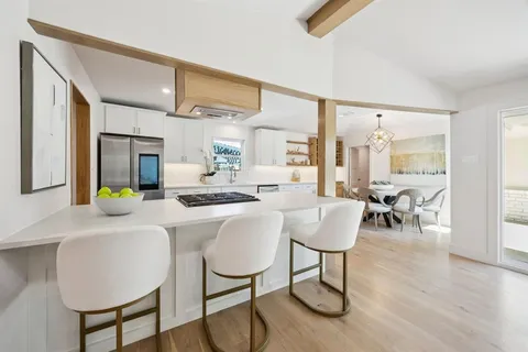 a dining room with furniture and wooden floor