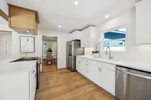 a large bathroom with a double vanity sink a mirror and a bathtub