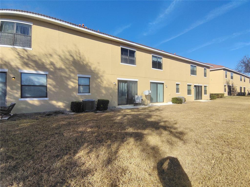 1423 Pacific Road Poinciana, FL 34759 - Photo 2 of 2 a front view of a house with a yard
