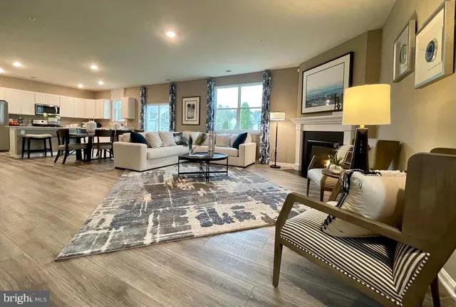 a living room with furniture fireplace and a table