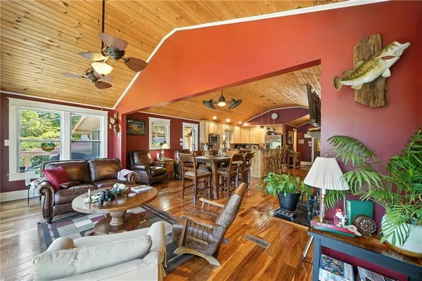 a living room with furniture a dining table and a potted plant