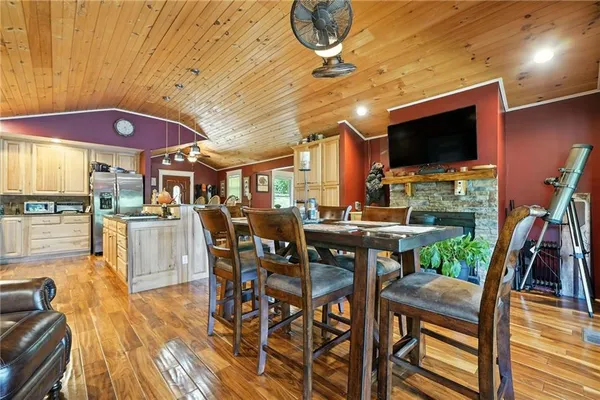 a kitchen with stainless steel appliances kitchen island granite countertop a stove and white cabinets