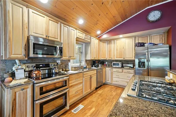 a view of a dining room with furniture wooden floor and a chandelier
