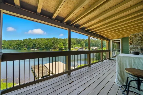 a view of a balcony with furniture and wooden floor