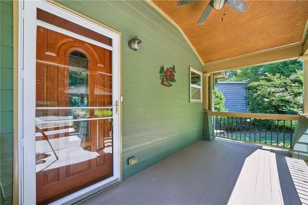 a balcony with furniture and a potted plant
