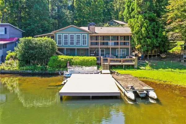 a view of a house with pool and chairs
