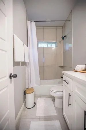 a bathroom with a toilet sink and shower