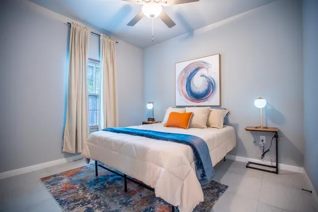 a bedroom with a bed and a lamp