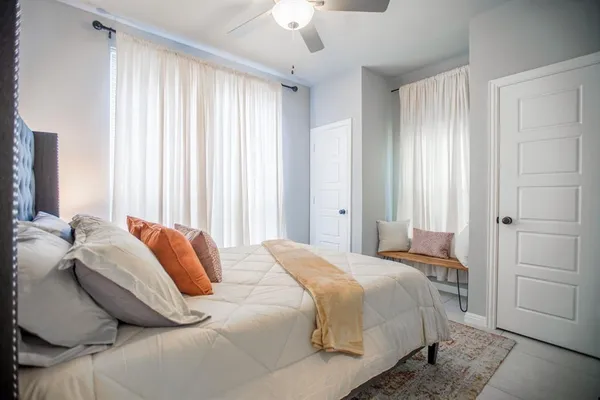 a bedroom with a bed and a chandelier