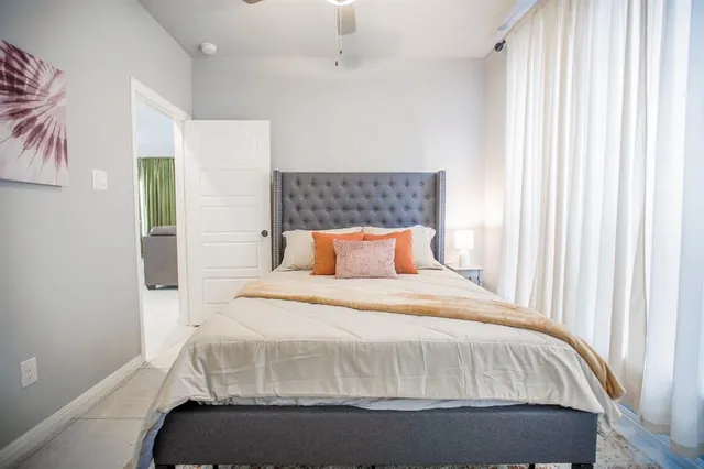 a bedroom with a bed and potted plant