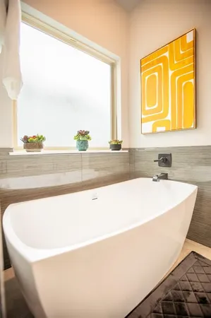 a white bath tub sitting next to a window