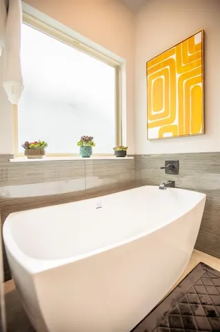 a white bath tub sitting next to a window